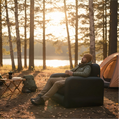 Person sitting on FREEIN Inflatable Camp Sofa Single at outdoor campsite